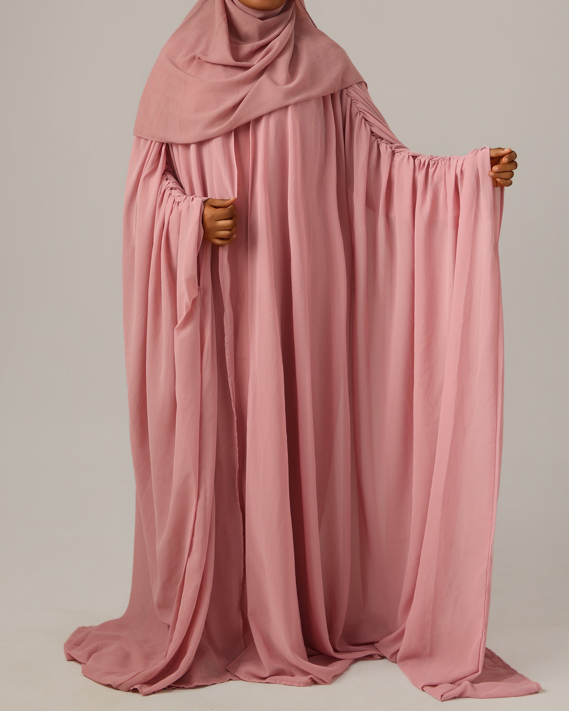 Pink abaya with a plain background