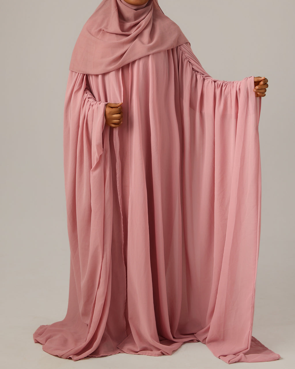 Pink abaya with a plain background